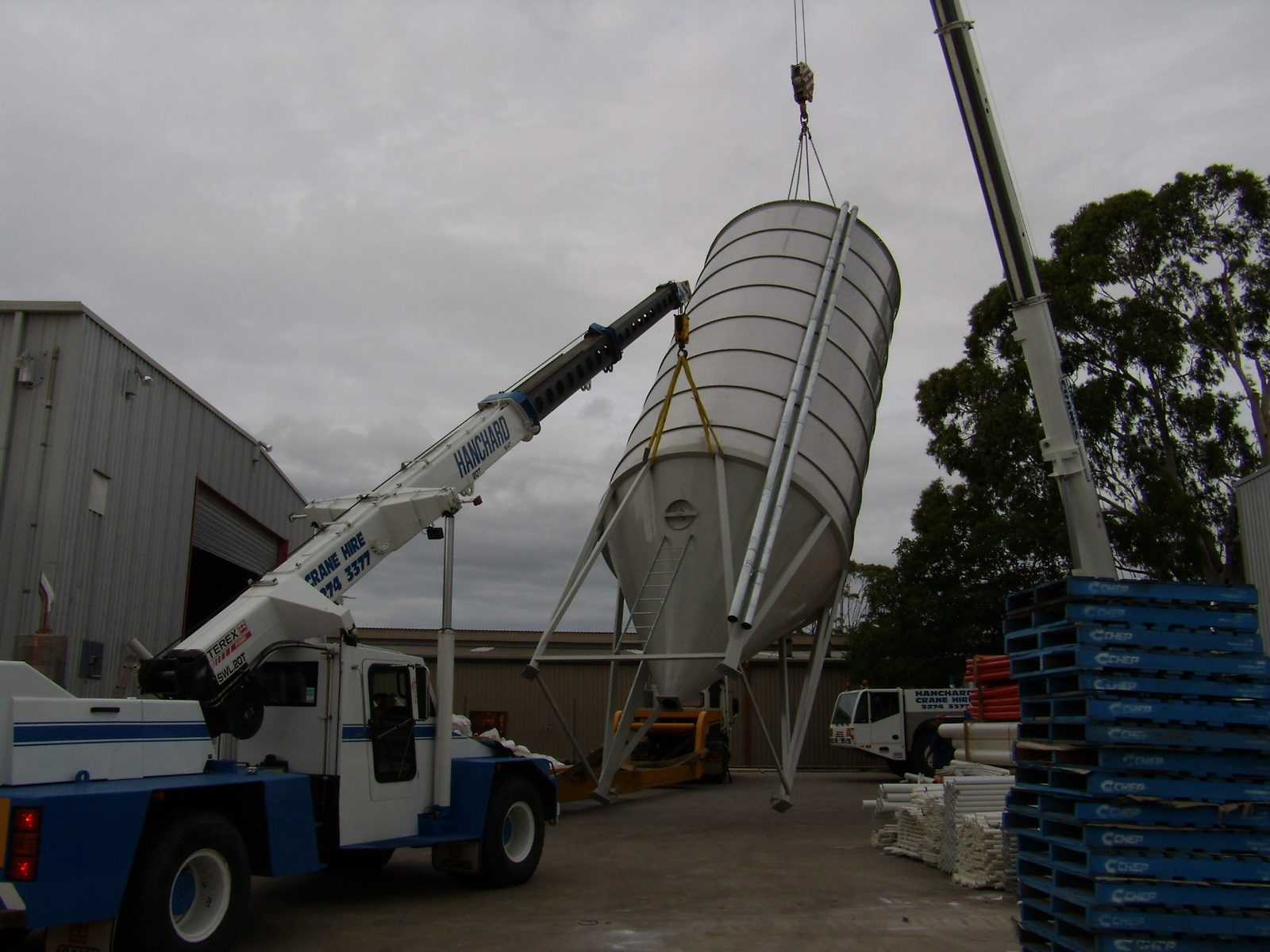 Silo being lifted into position by crane